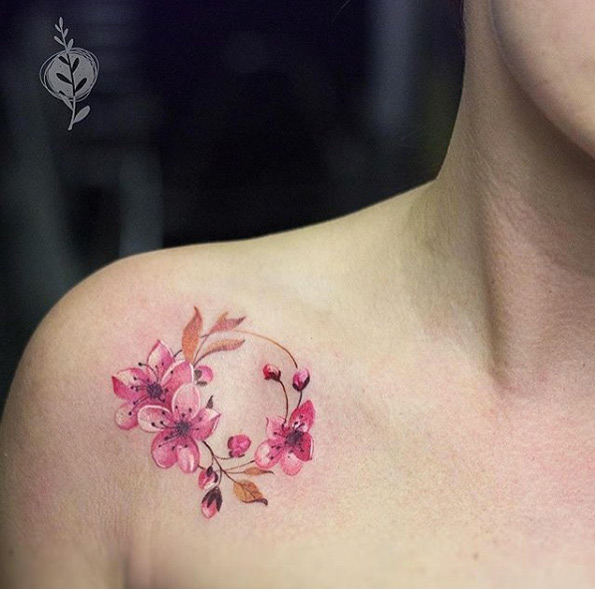 Circular cherry blossom tattoo on shoulder by Redberry Tattoo Studio