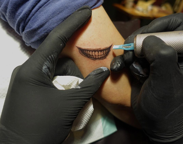 Smiling tattoo by Nando