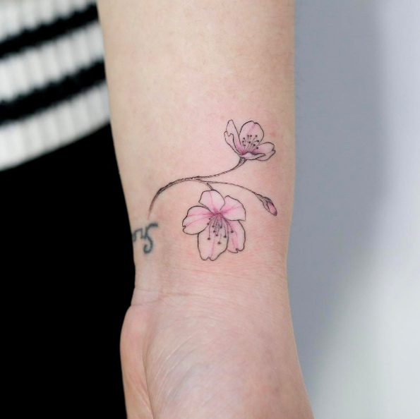Cherry blossom wrist tattoo by Tattooist Doy