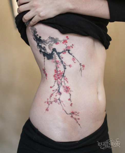 Sprawling cherry blossom side piece by Tattooist River