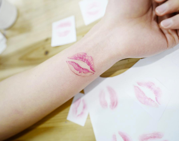 Pink lips on wrist by Banul