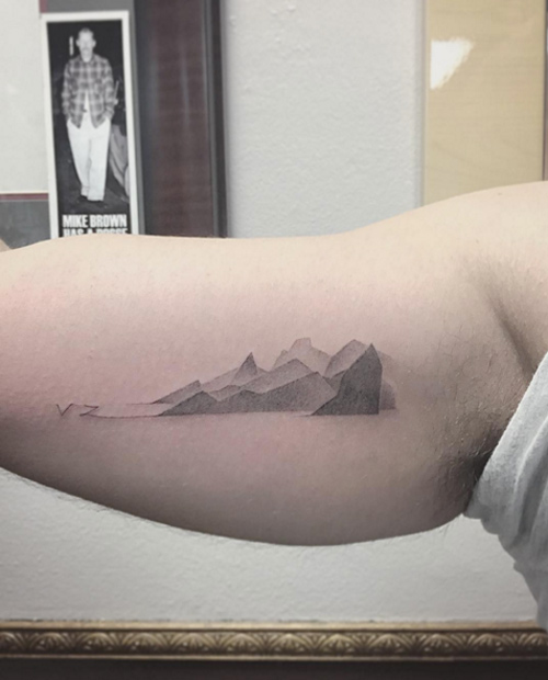 Distant mountain range tattoo by East Iz