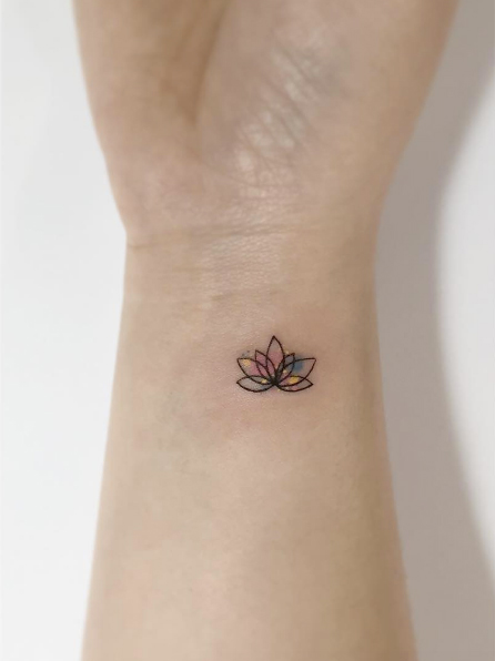 Micro lotus flower tattoo by Playground Tattoo