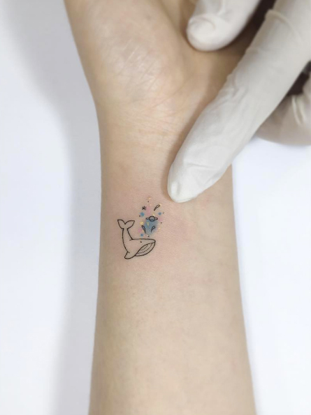 Tiny whale tattoo by Playground Tattoo
