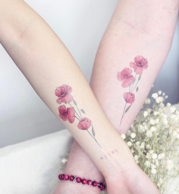 Matching floral tattoos by Mini Lau