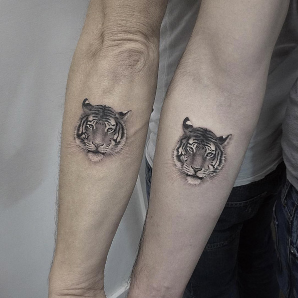Matching tiger tattoos by Lazer Liz