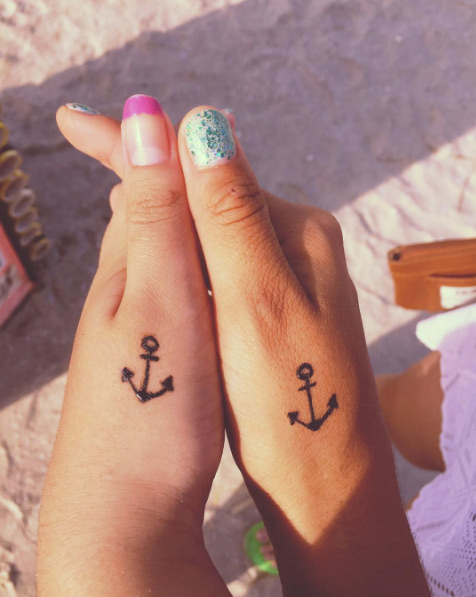 Matching anchor tattoos by Nasle Briones