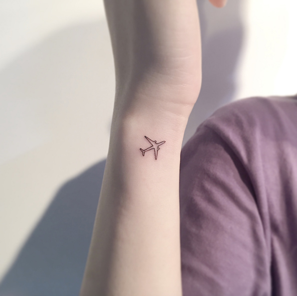 Small airplane by Playground Tattoo