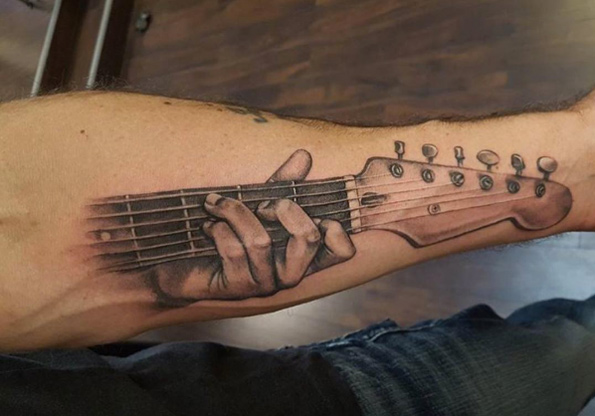Guitar tattoo by Adept Tattoos