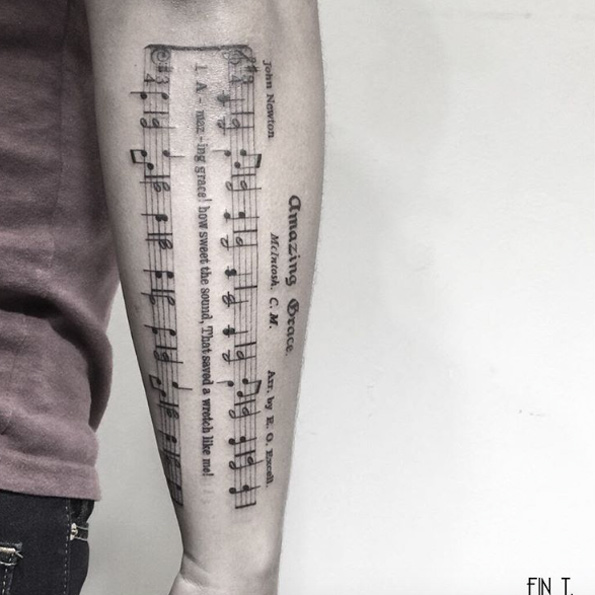 Sheet music tattoo by Fin Tattoos