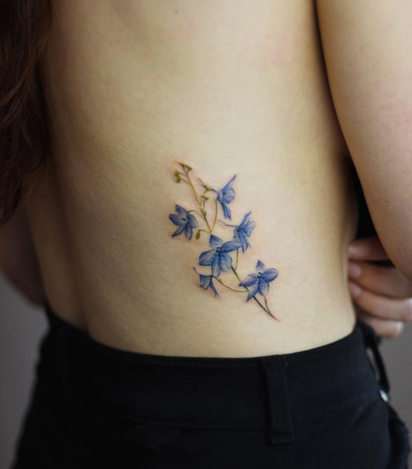 Delphinium flower tattoo by Cindy Vanschie