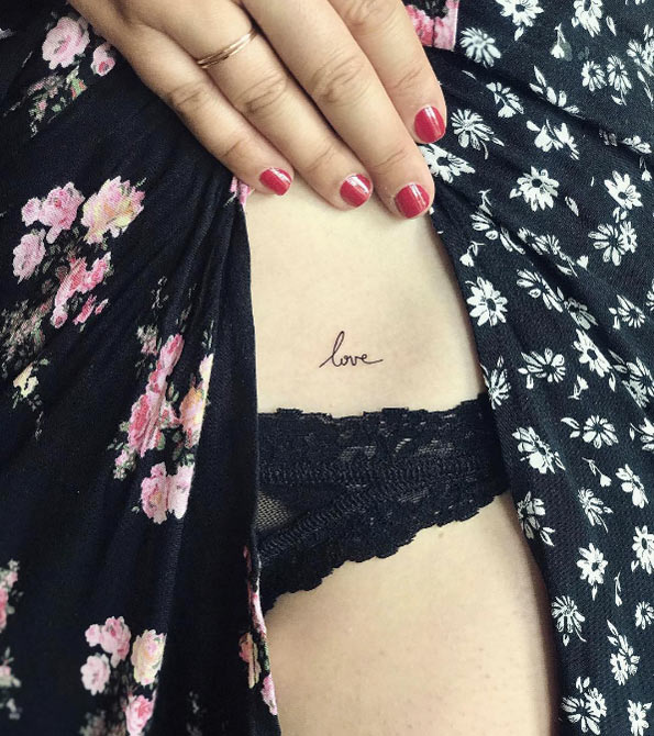 Small "love" tattoo by Laura Martinez