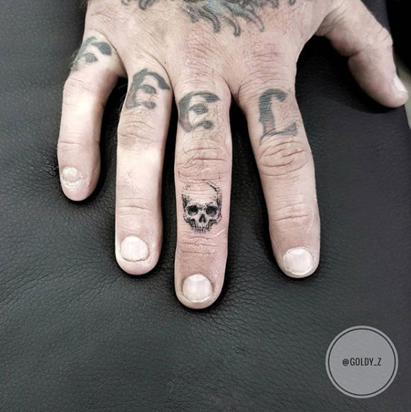 Tiny skull finger tat by Zlata Kolomoyskaya
