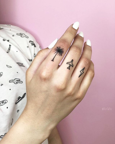 Palm, plane, and lightning bolt finger tattoos by Vivo