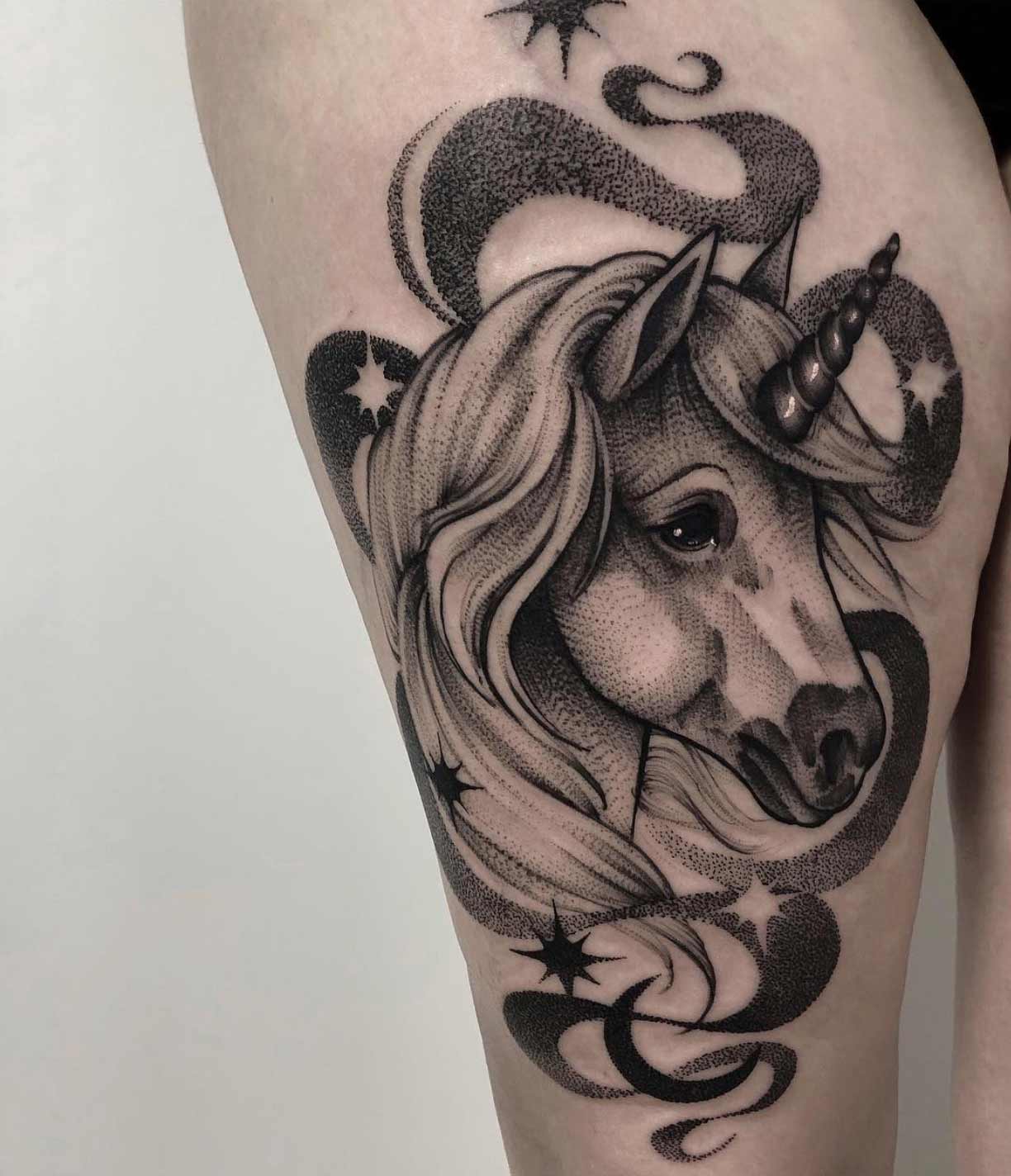 A unicorn thigh piece by Hipner