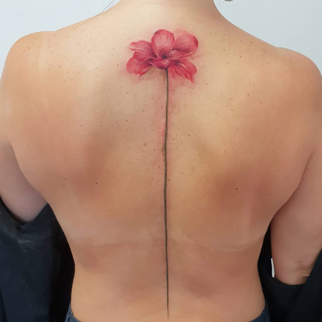 A floral back piece by Jemka